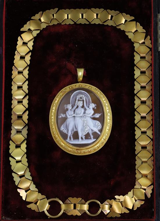 A Victorian gold mounted oval cameo pendant, carved with the Three Graces, in fitted box with gold fancy link chain,